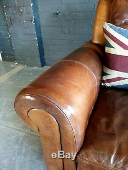 2004. Chesterfield tan Distressed Vintage Club Leather Armchair Courier Available