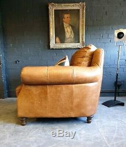 3008. Chesterfield tan Vintage Club Leather Armchair & Pouffe Courier av