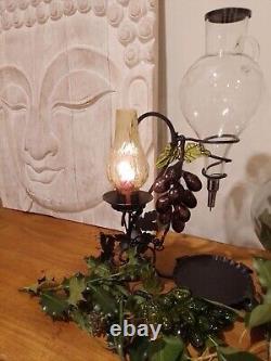 Vintage decorative wrought iron wine dispenser with glass candle vase