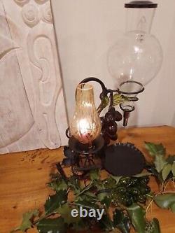 Vintage decorative wrought iron wine dispenser with glass candle vase