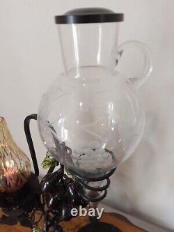 Vintage decorative wrought iron wine dispenser with glass candle vase