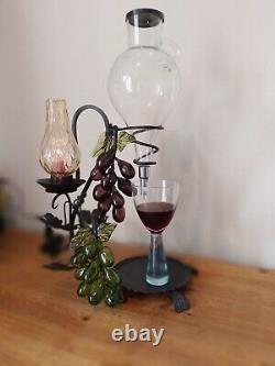 Vintage decorative wrought iron wine dispenser with glass candle vase