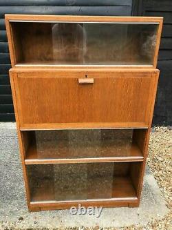 Vintage lockable drop front bureau cabinet with glass sliding display sections