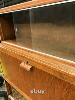 Vintage lockable drop front bureau cabinet with glass sliding display sections