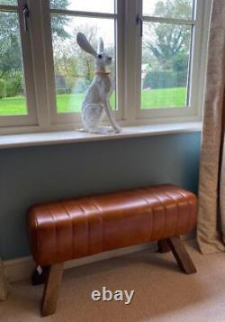 Banc en cuir marron, pieds en bois, style cheval d'arçons rétro vintage.