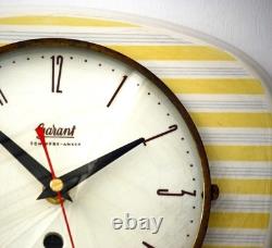 Horloge murale vintage Garant en céramique de 26 cm, style rétro milieu de siècle, jaune, allemande